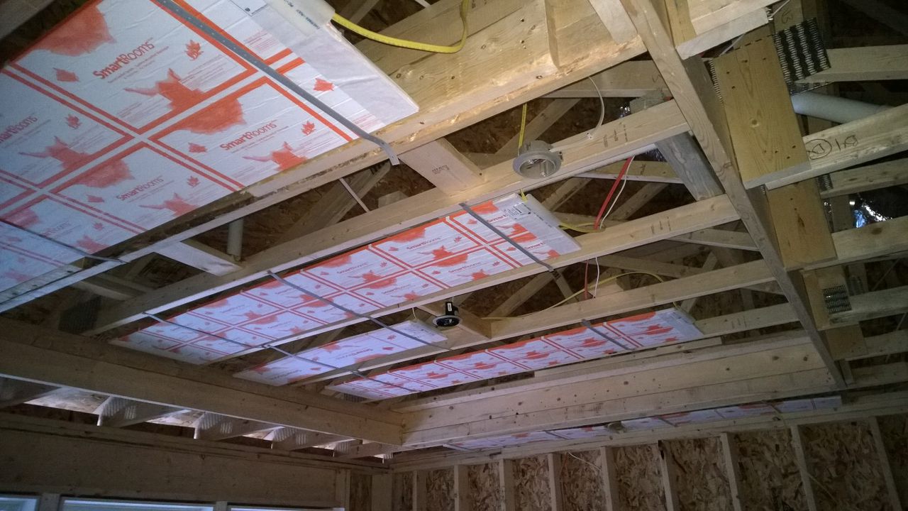 Radiant ceiling panels between exposed ceiling joists before drywall
