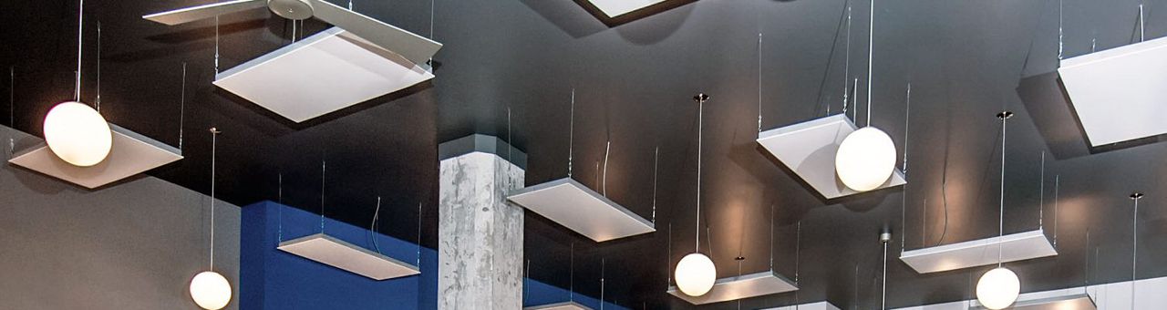 Architectural Series heaters hung on cables among pendant lights at Hudson Yoga