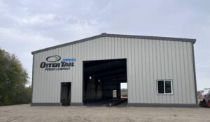 an uncompleted warehouse with dirt and sand in the surrounding areas. Hoot Lake Solar's operations building